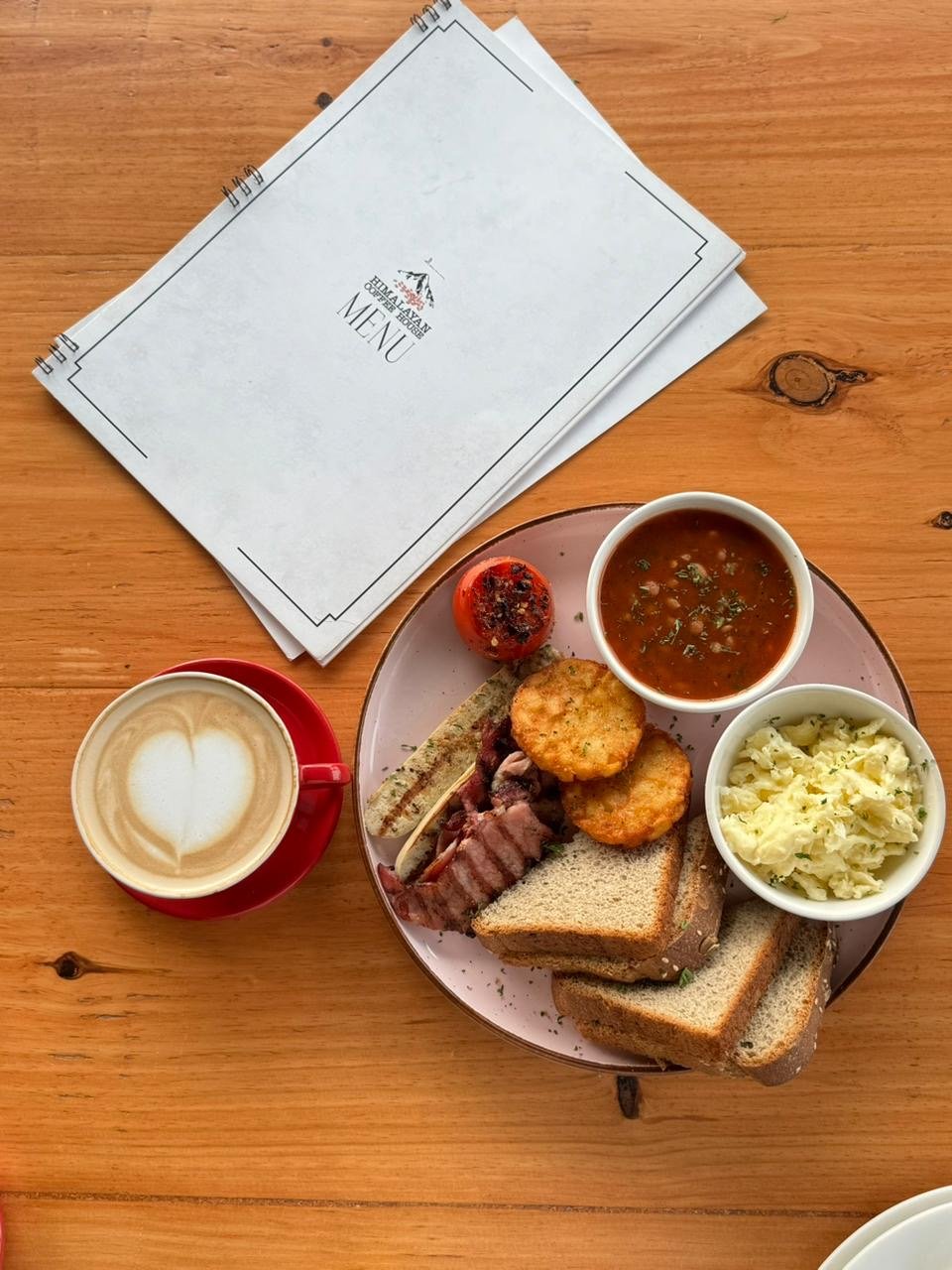 English breakfast with toast, hash browns, sausage, baked beans and a latte